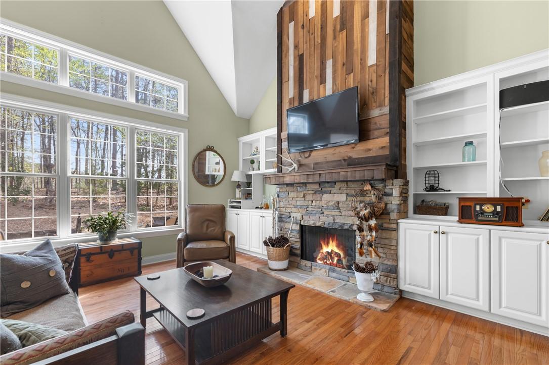 Image 3: This inviting living space features warm hardwood