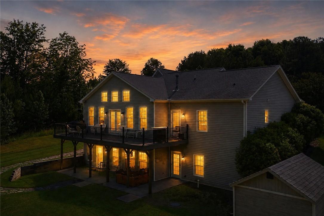 Image 3: Perched amidst a vibrant sunset, this inviting hom