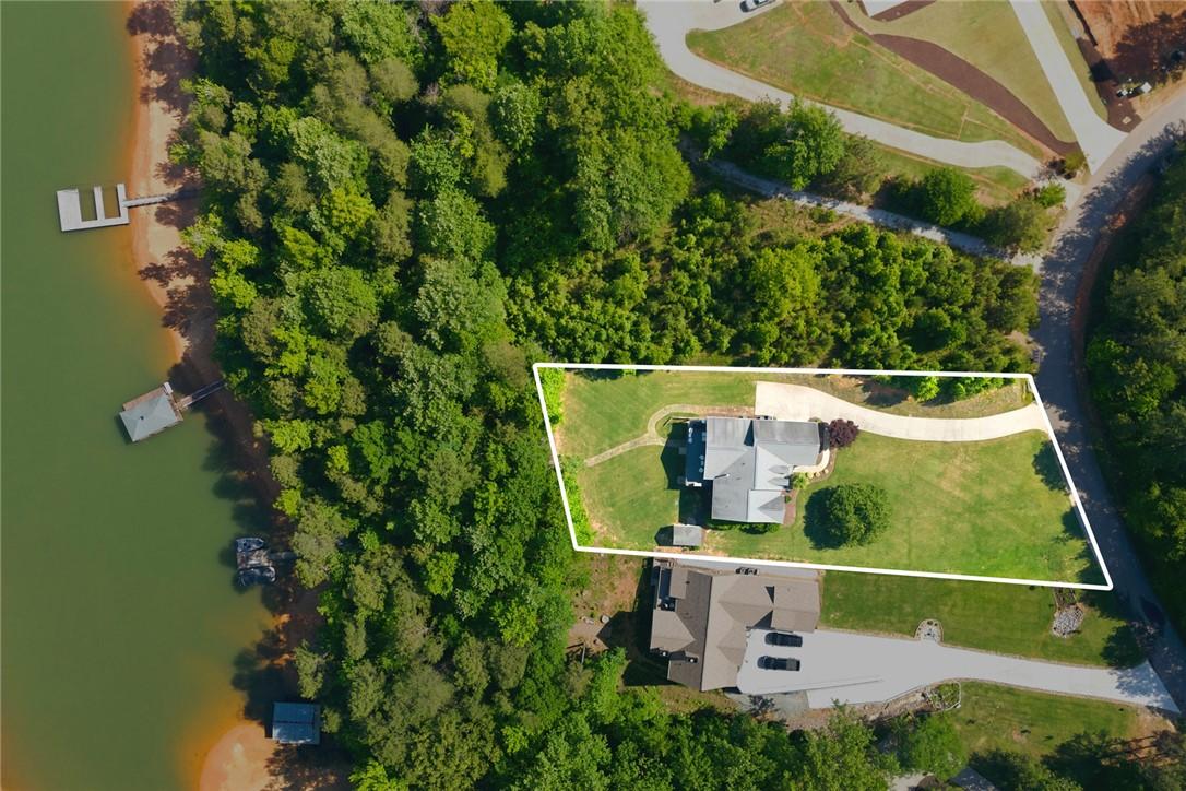 Image 4: Aerial view reveals a sprawling lakeside estate wi
