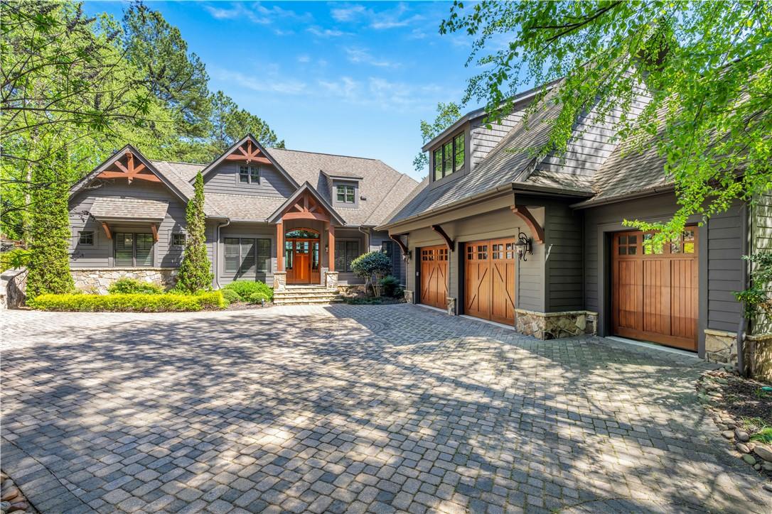 Image 1: This charming home offers a spacious driveway, pro