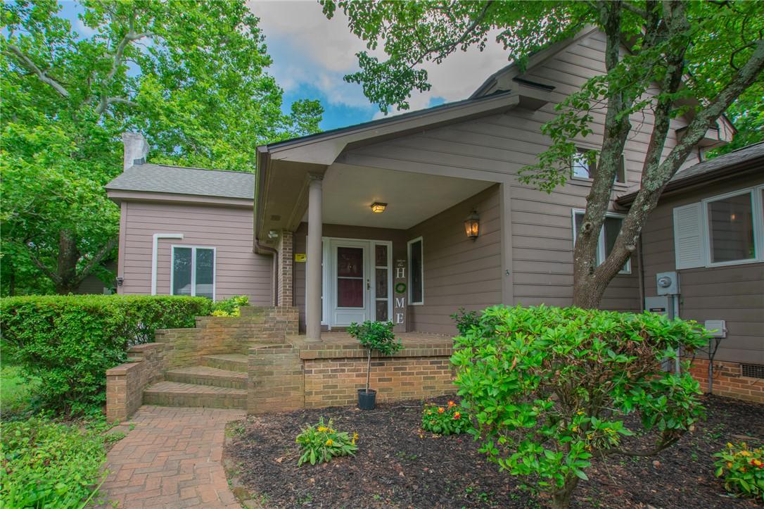 Image 4: A welcoming brick pathway leads to the inviting fr
