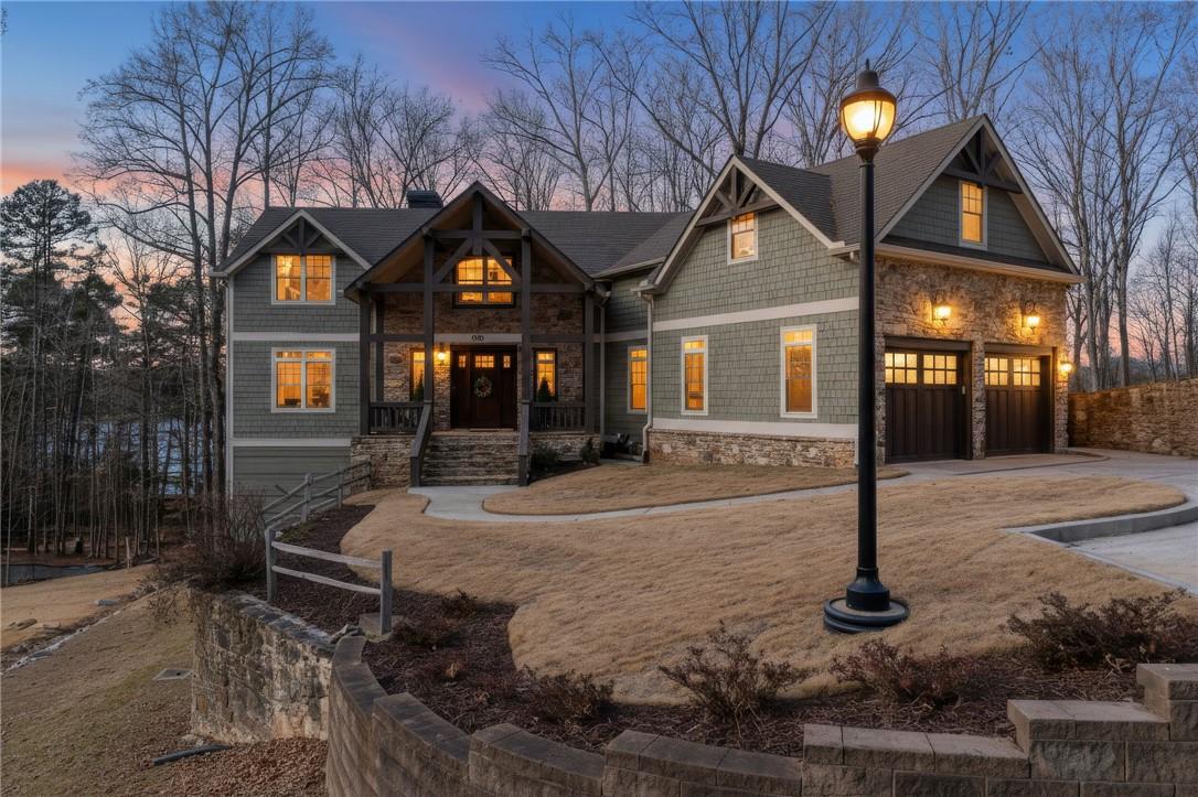 Image 1: This exquisite lakefront residence features a ston