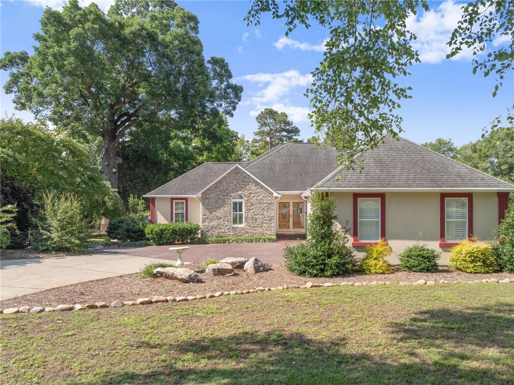 Image 2: A gracefully designed home featuring stone accents