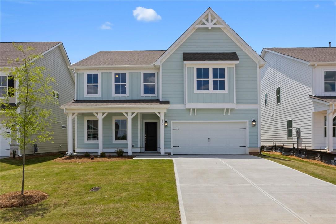 Image 1: Two-story home with a pristine fa&ccedil;ade and an attac