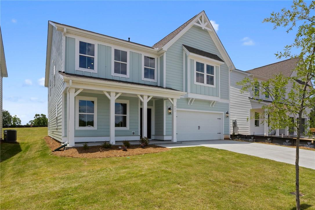 Image 2: A charming residence with a covered front porch an