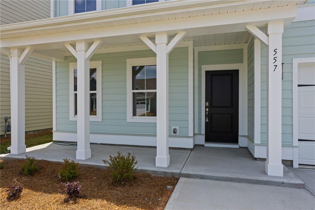 Image 3: A welcoming covered entry porch introduces this in