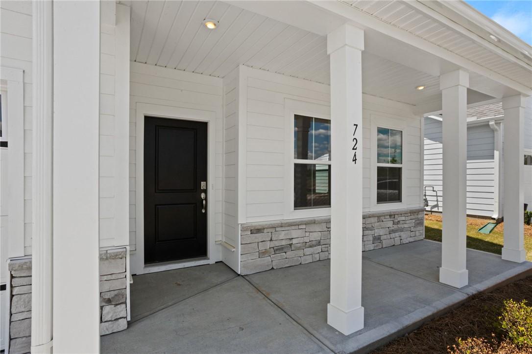 Image 3: A welcoming covered porch with sleek white columns