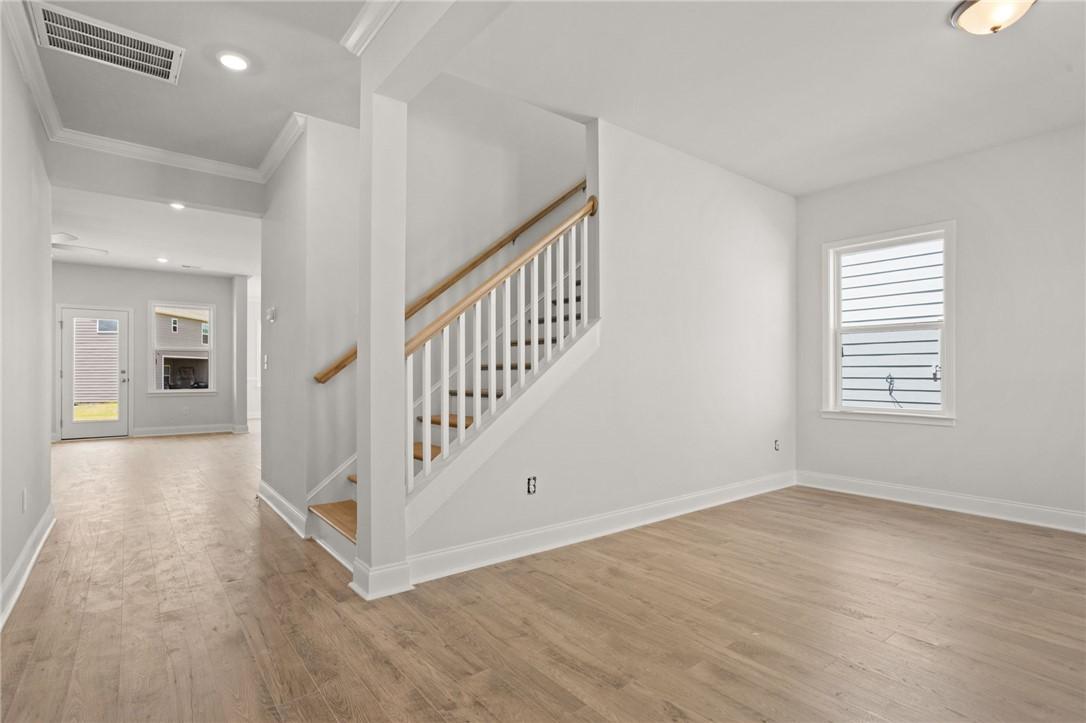 Image 4: Laminate flooring extends through an open living a