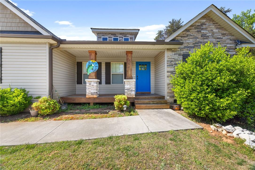 Image 4: This inviting home features a charming covered fro