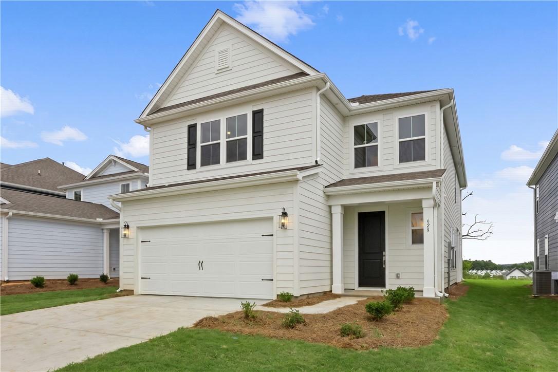 Image 2: A pristine two-story residence with a welcoming fr