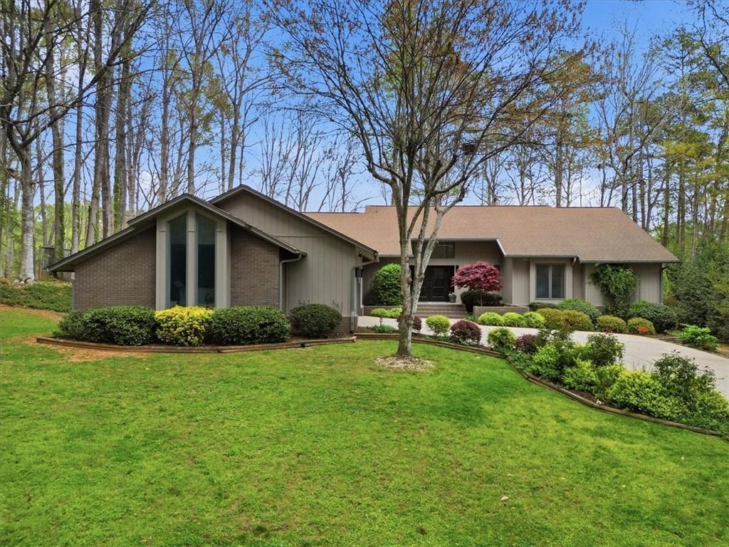 Image 2: This residence features a brick and siding exterio