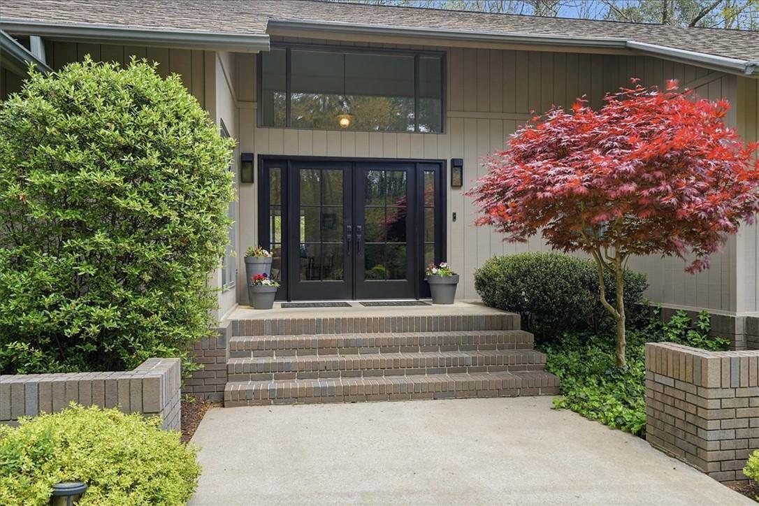 Image 4: This inviting entrance features brick steps leadin