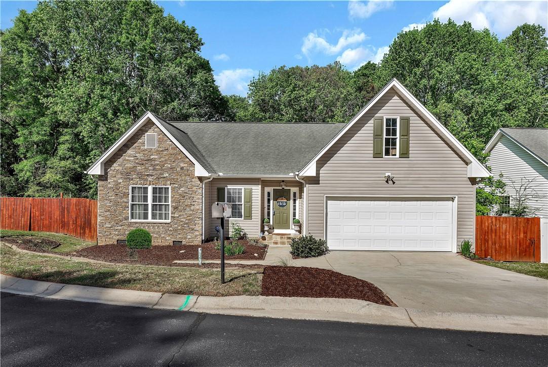 Image 1: This charming home presents an inviting facade wit