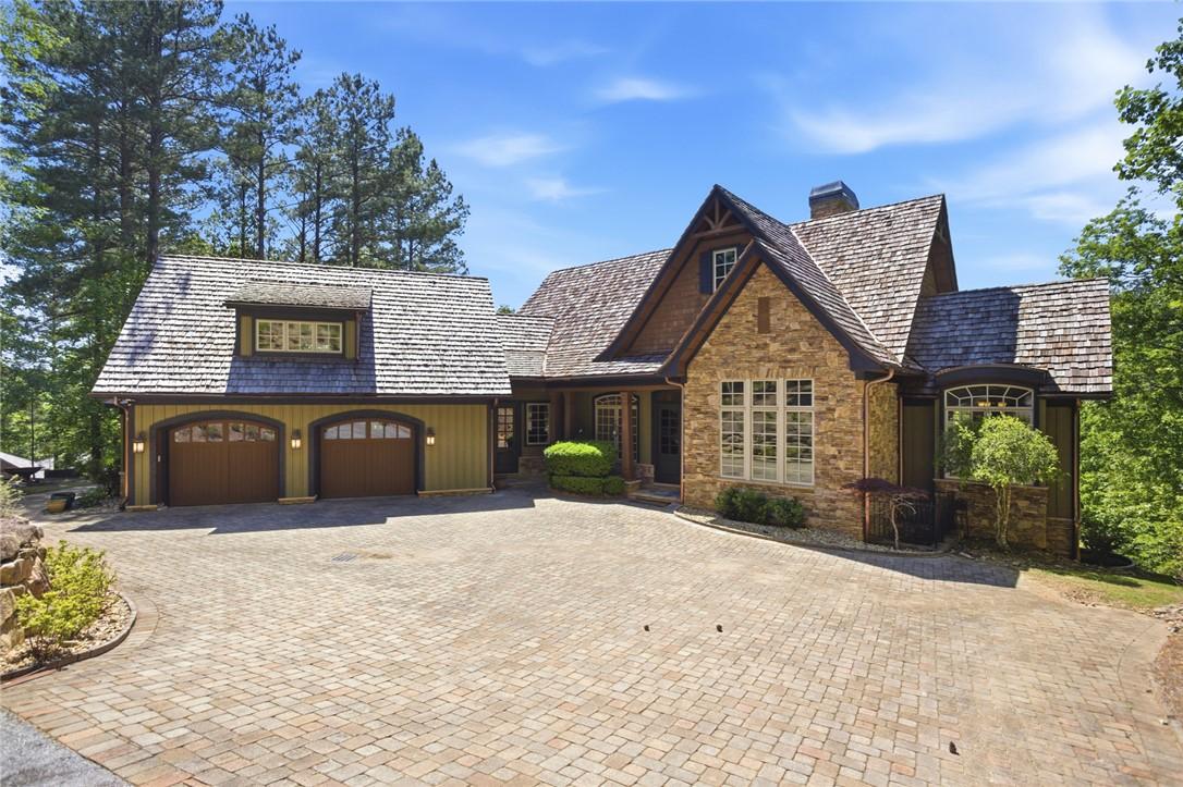 Image 1: Crafted with stone and wood accents, this home fea