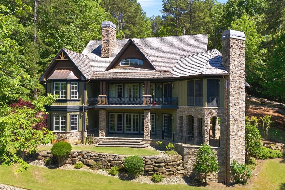 Image 2: This charming home is nestled amongst mature trees