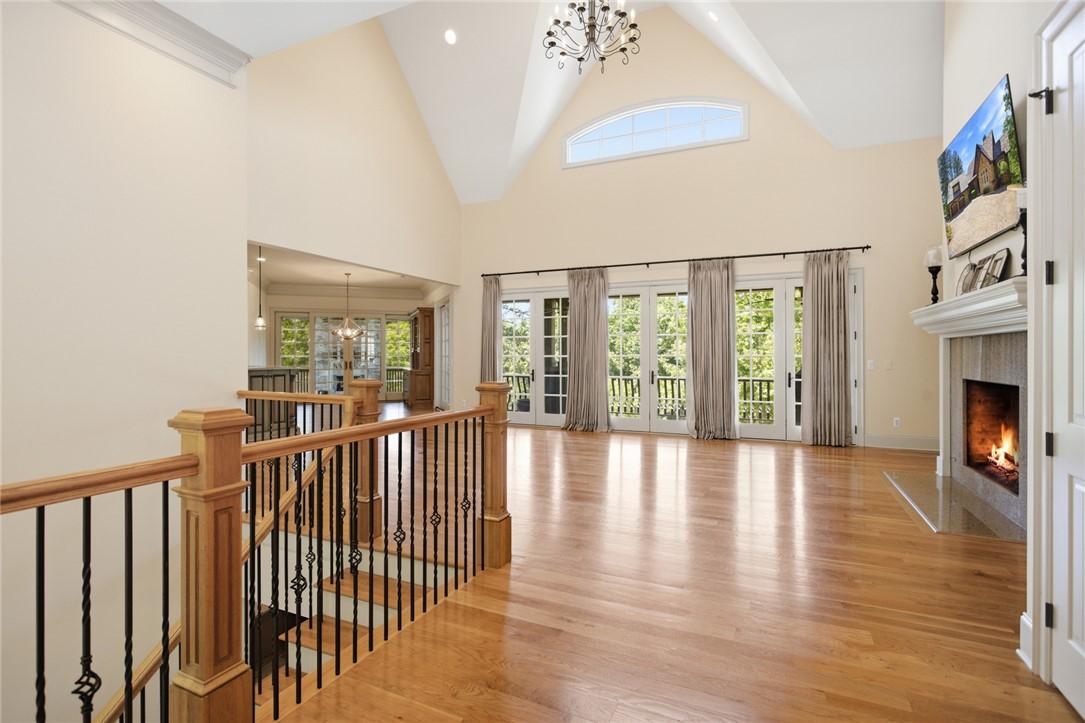 Image 3: Grand living area with vaulted ceilings and a warm