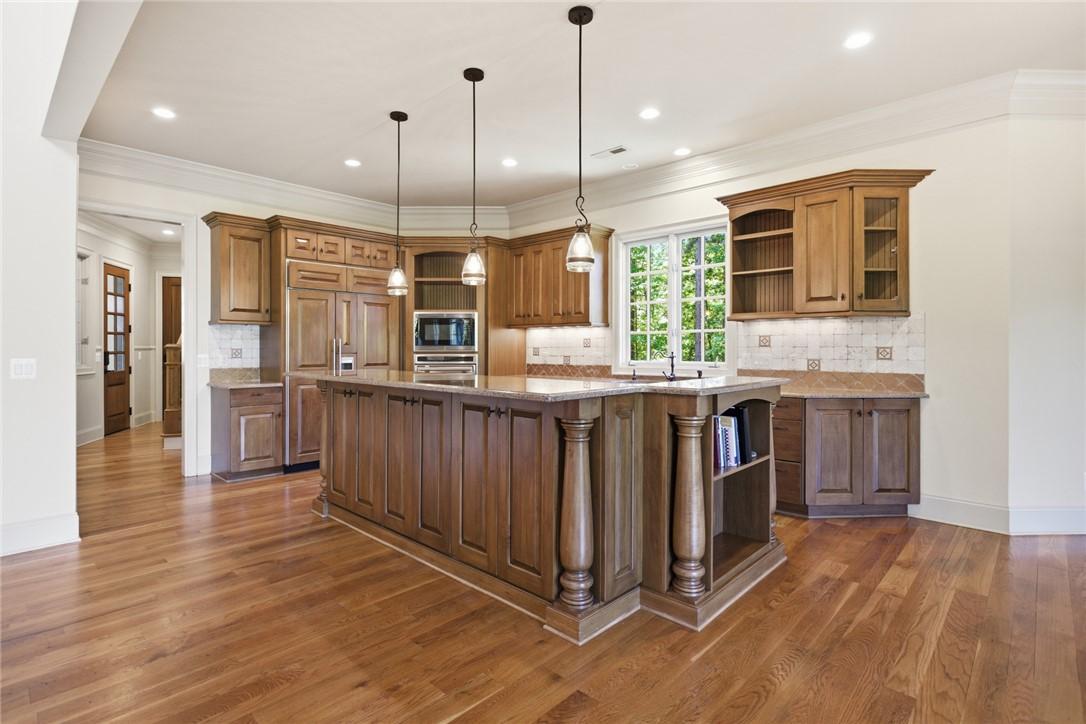 Image 4: A well-appointed culinary space featuring rich woo