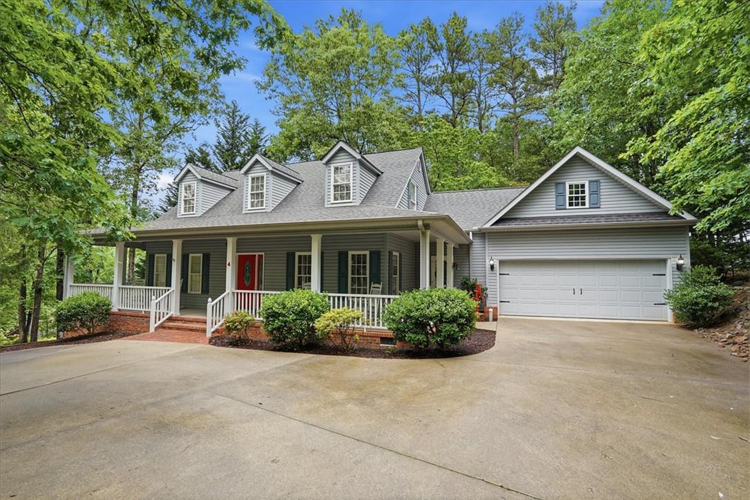 Image 1: A welcoming traditional-style home with dormer win