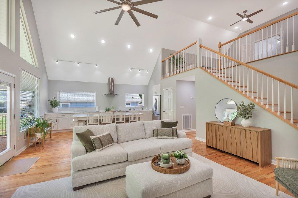 Image 4: A grand, open-concept living space features vaulte