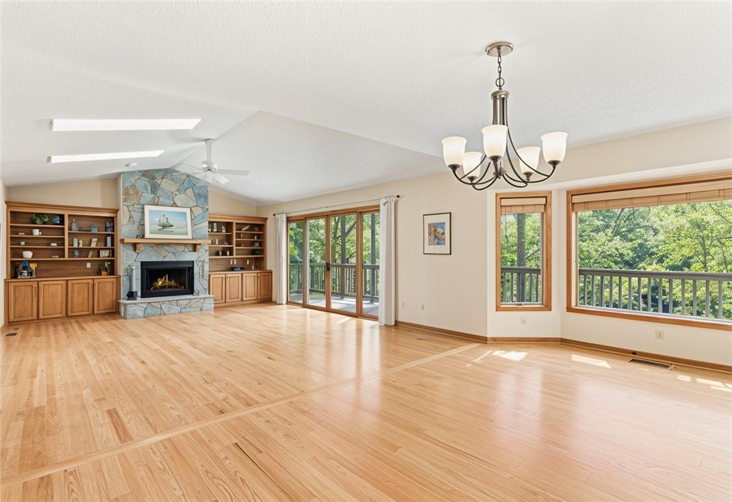 Image 2: This airy living space features a cozy fireplace a