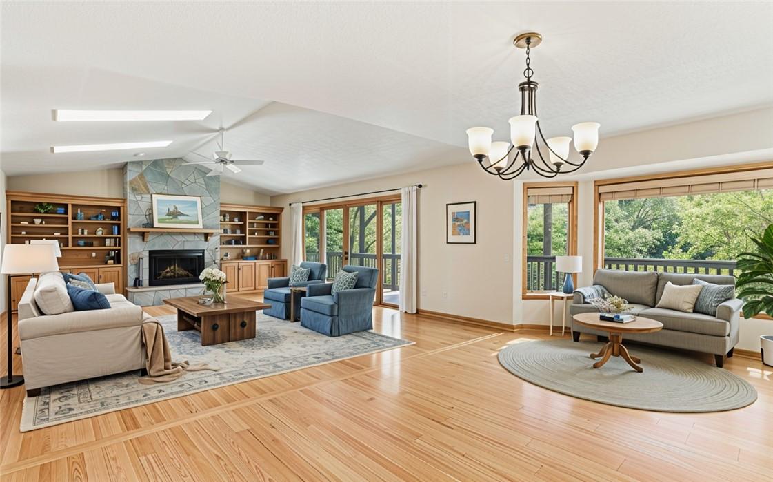 Image 3: This inviting living area features a stone firepla