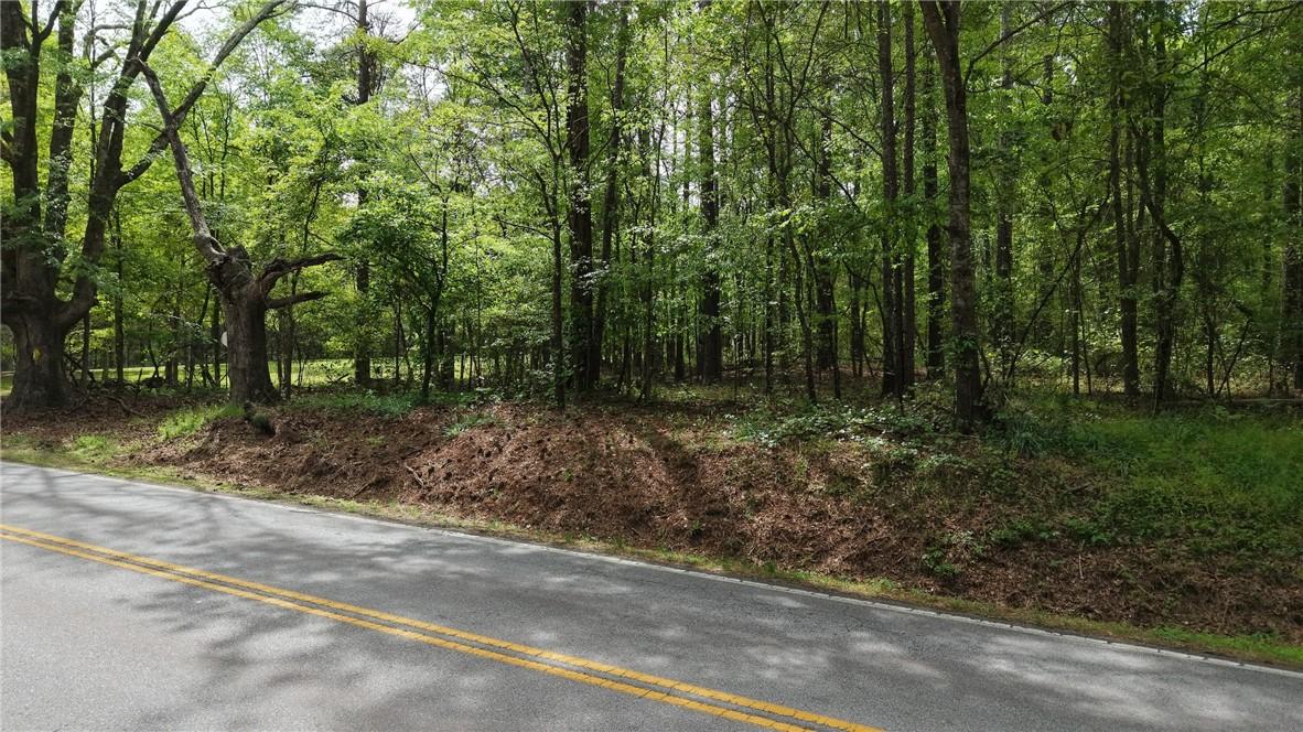 Image 3: This scenic wooded lot offers a tranquil setting f