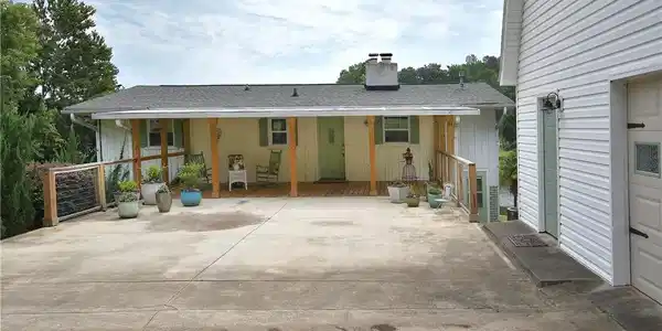 Image 2: A charming home with an inviting porch and ample d