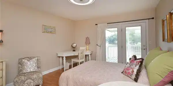 Image 4: Hardwood floors and waterfront balcony access elev