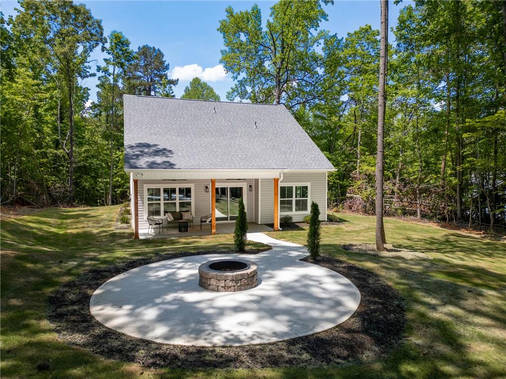 Image 4: A quaint abode with a inviting covered patio and f