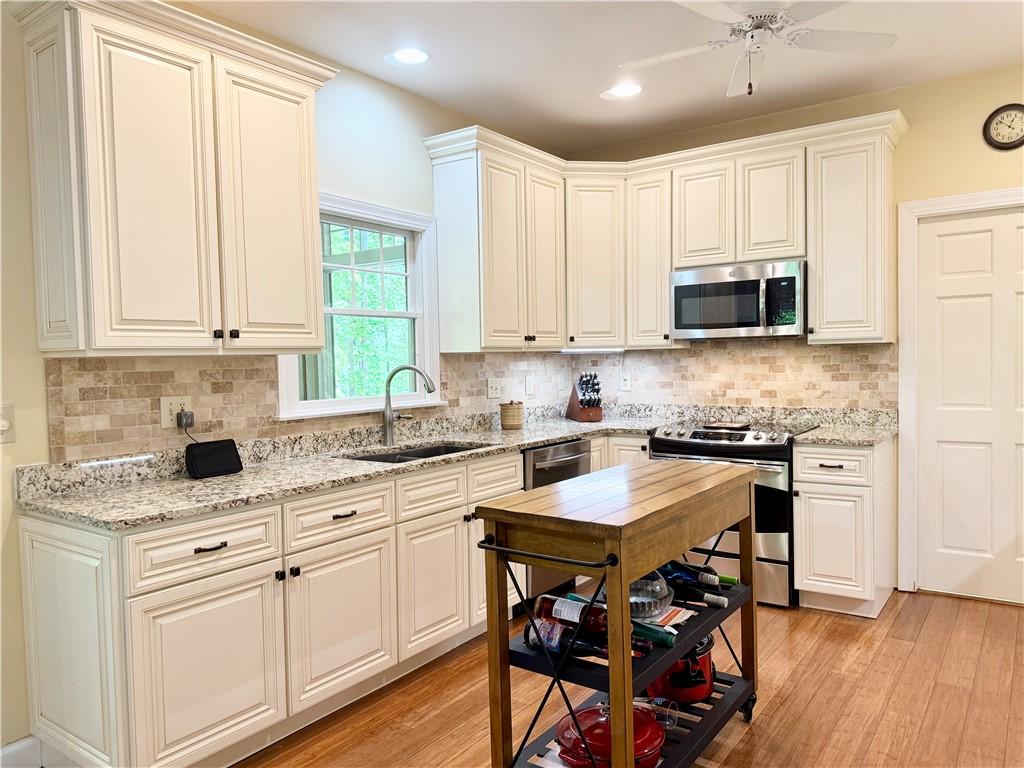 Image 4: This spacious kitchen offers ample cabinet space a