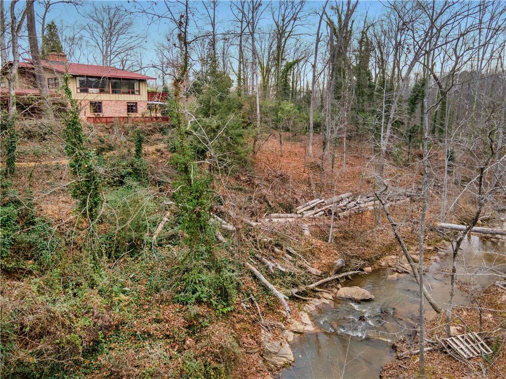 Image 3: This secluded residence features a brick exterior