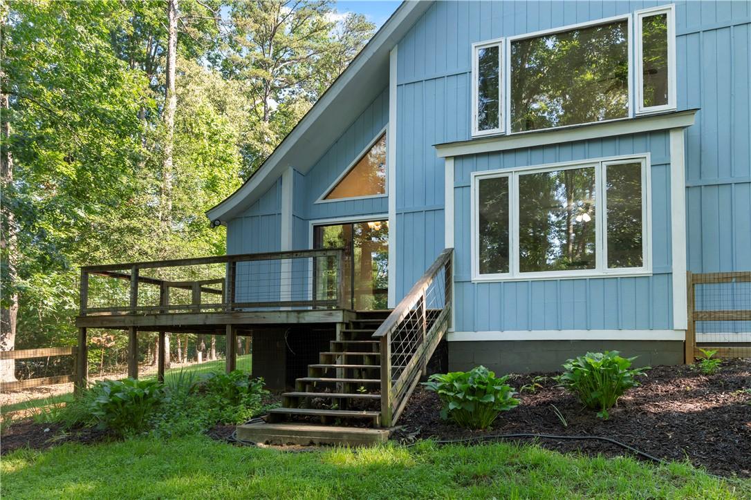Image 3: A sprawling wrap-around deck offers serene outdoor