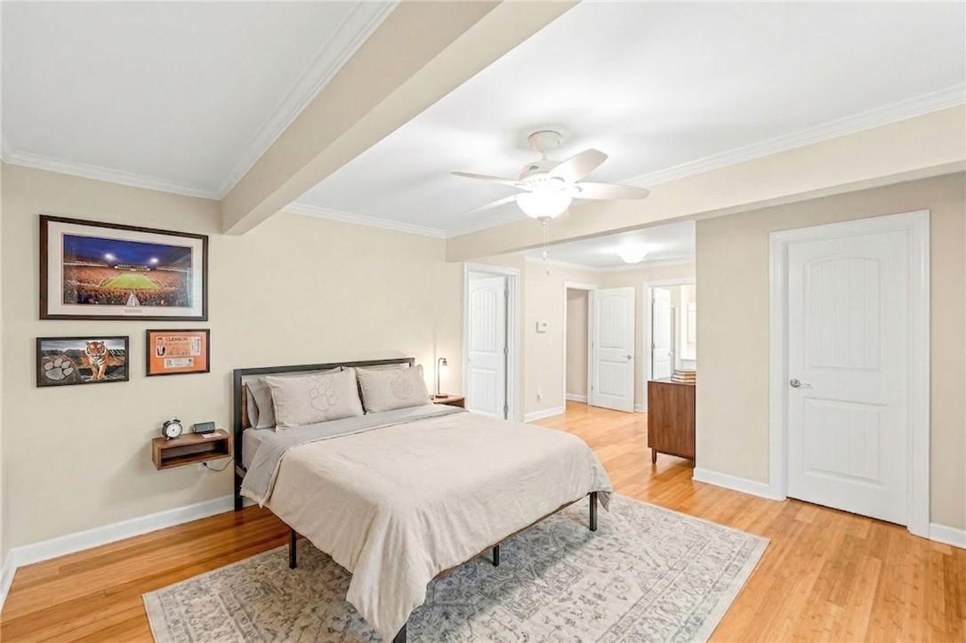 Image 3: Hardwood floors and crisp crown molding frame this
