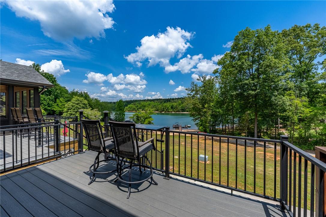 Image 3: Unwind on the outdoor deck, gazing upon serene lak