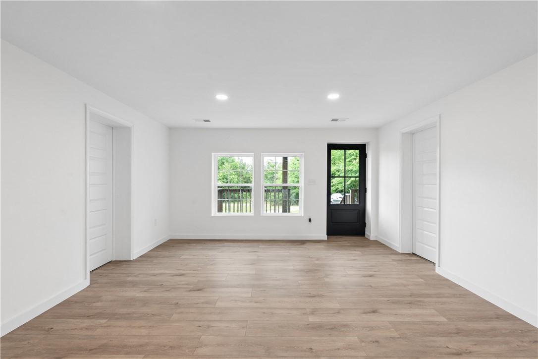 Image 3: Recessed lighting illuminates wood-look flooring a