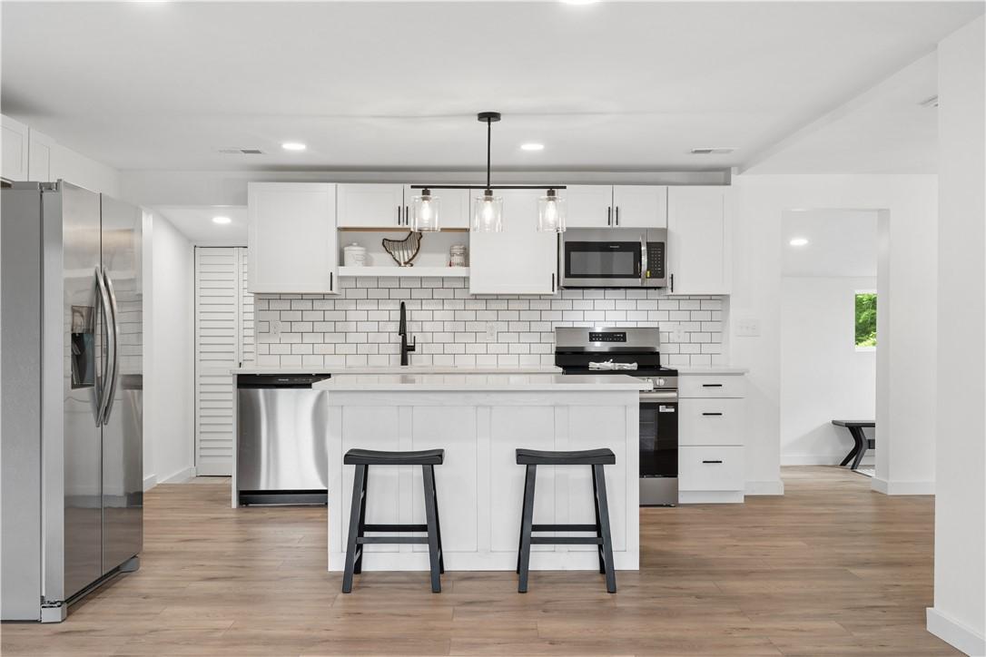 Image 4: A contemporary kitchen features bright white cabin