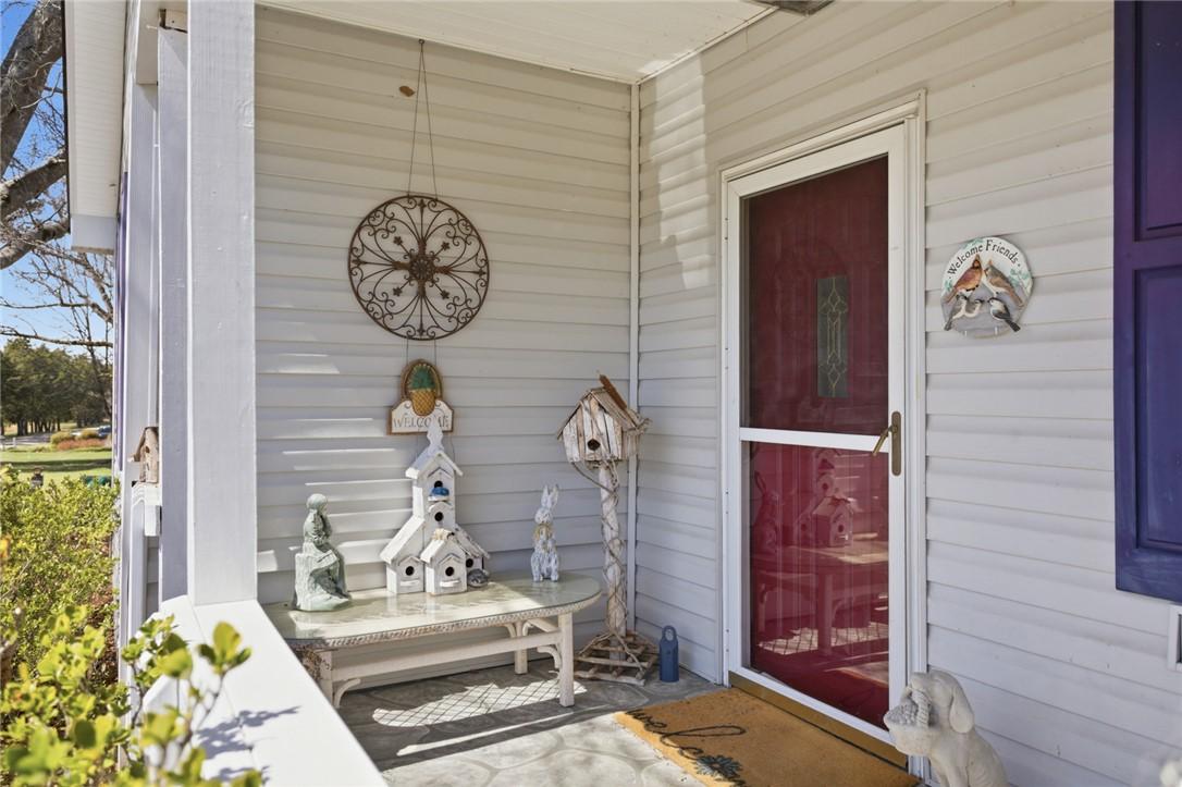 Image 4: This inviting porch offers a warm welcome to all w