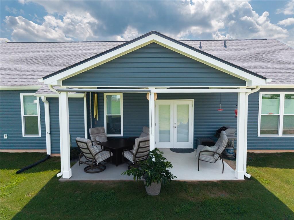 Image 2: A spacious covered patio offers ample room for out
