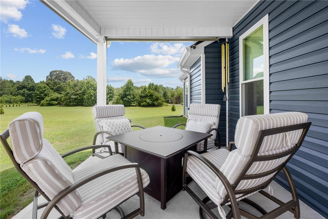 Image 3: Relax on the covered patio, embracing expansive gr