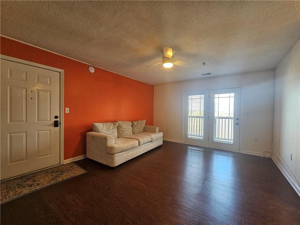 Image 4: This inviting living space features rich hardwood