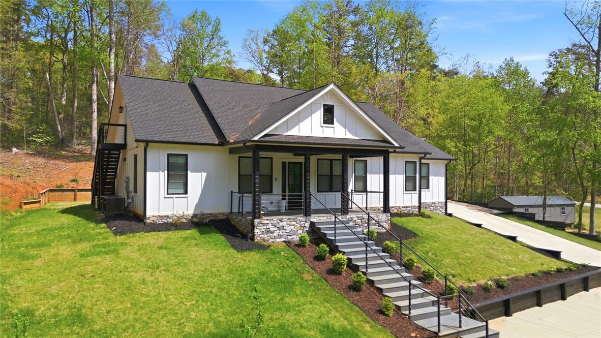 Image 2: This charming home sits on a verdant hillside, boa