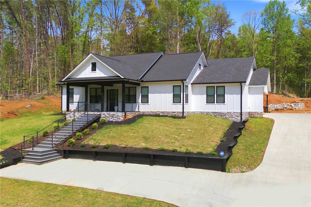 Image 4: This newly constructed home boasts a classic facad