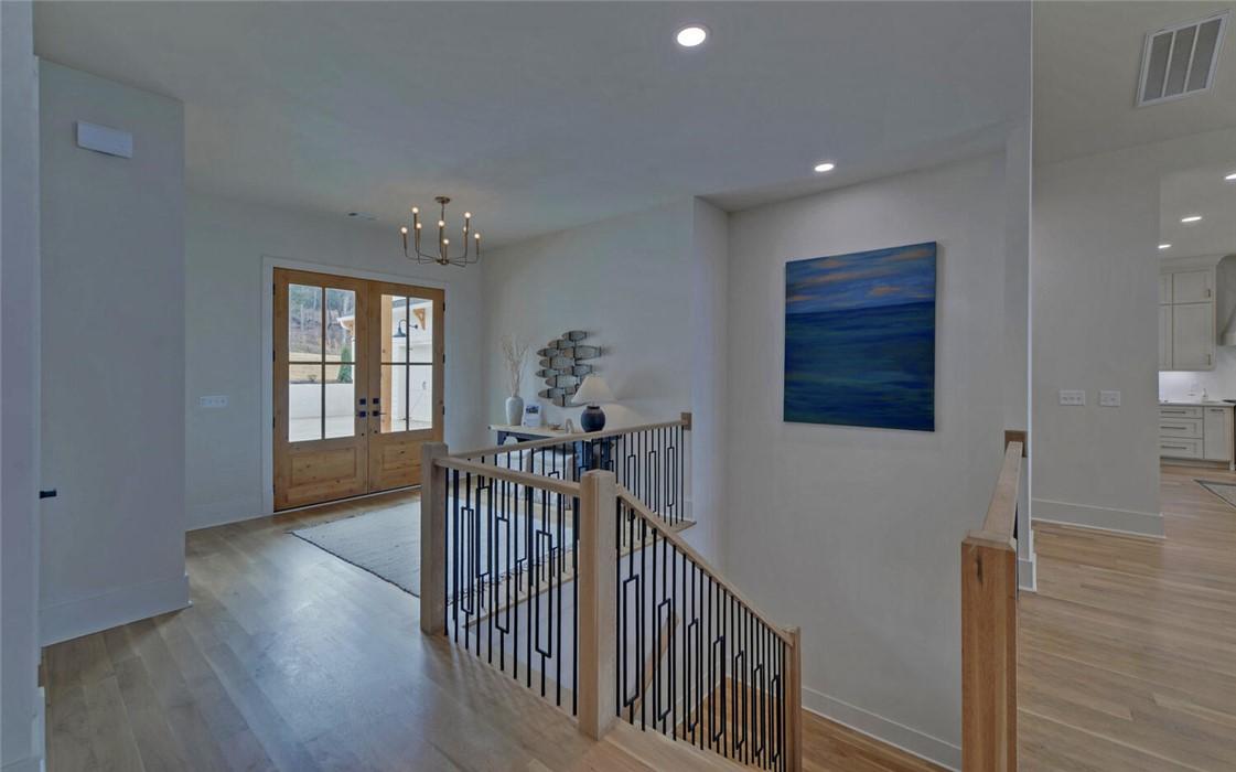 Image 4: This bright entrance welcomes guests with warm woo