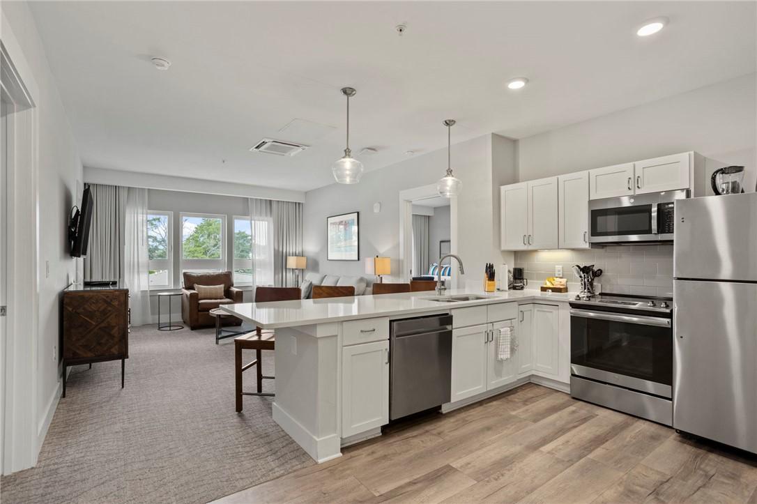 Image 2: This open concept kitchen and living area offers b
