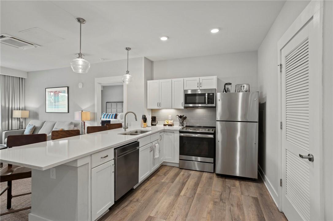 Image 4: This modern kitchen features stainless steel appli