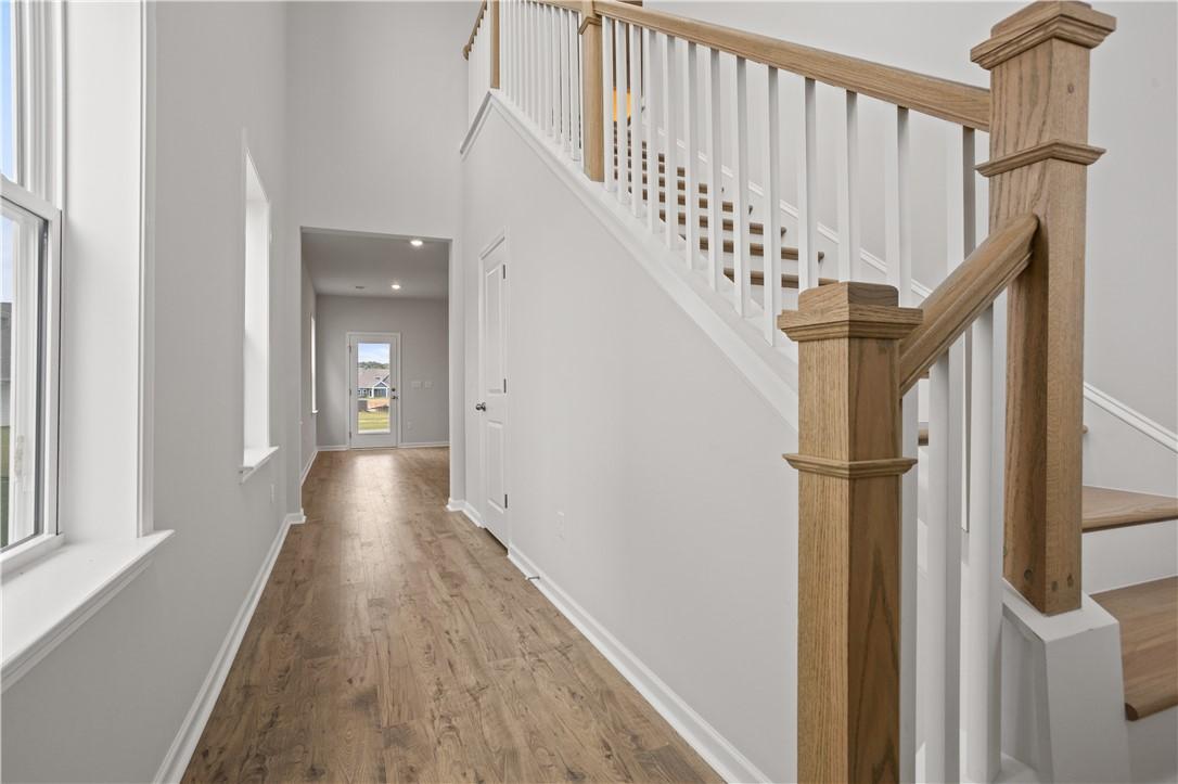 Image 4: A grand entrance with high ceilings, warm wood flo