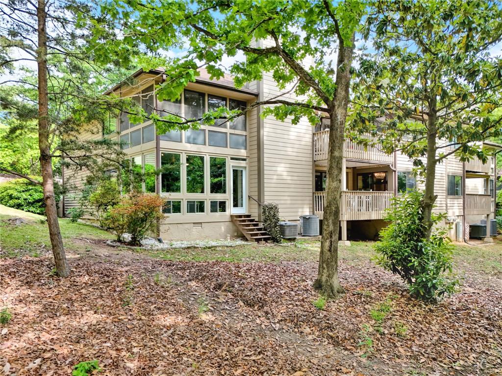 Image 2: This residence features expansive windows and outd