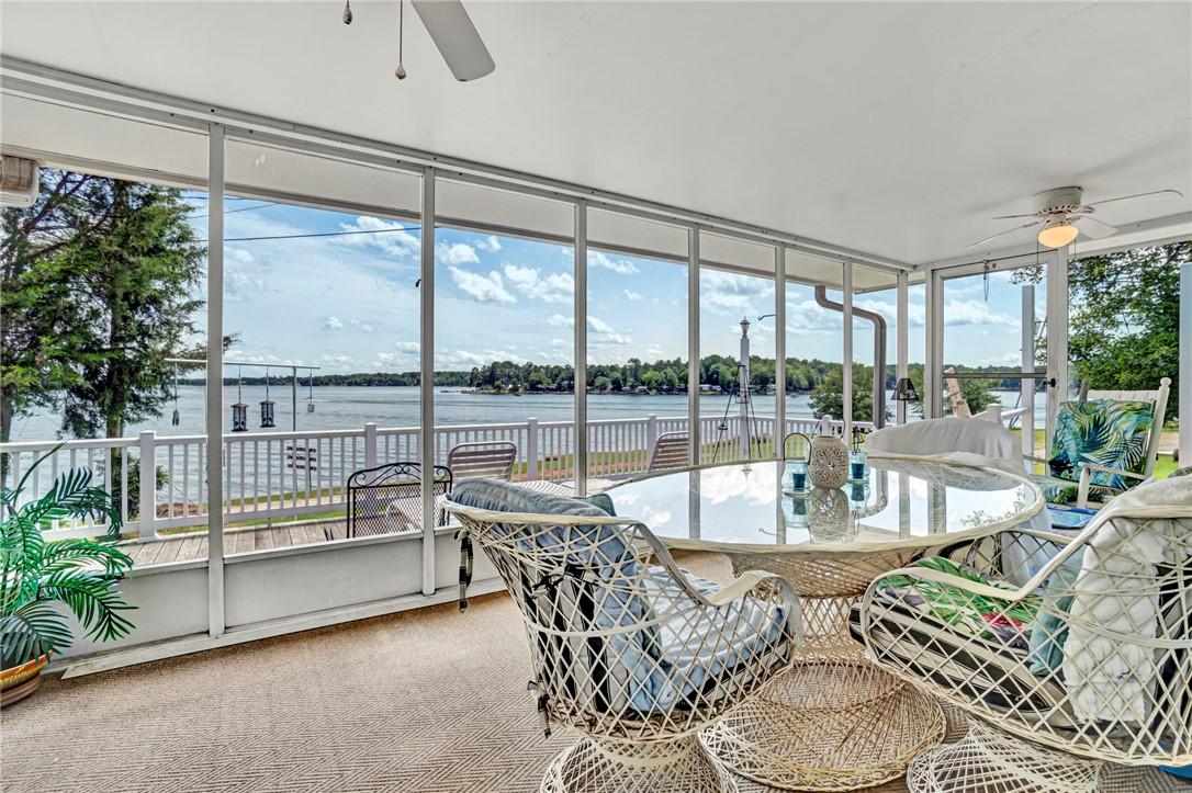 Image 1: Panoramic lake views from this sun-filled screened