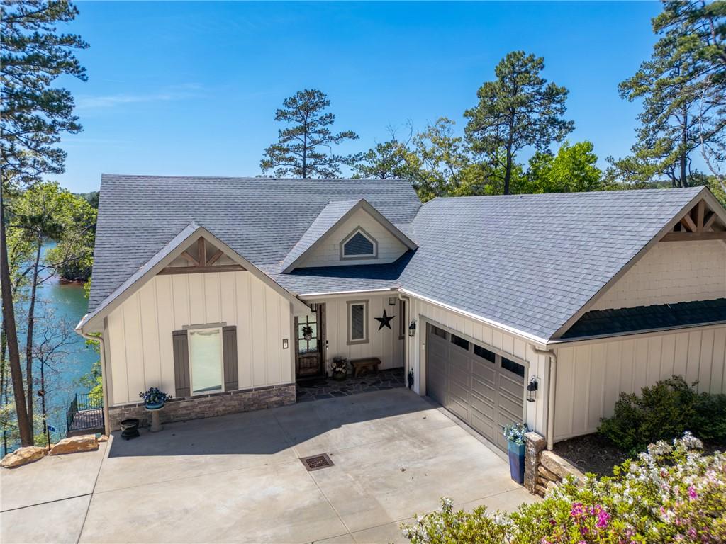 Image 1: This charming lakeside residence features a classi