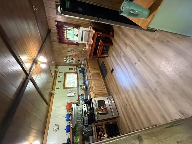 Image 4: A quaint kitchen boasts warm wood paneling and nat